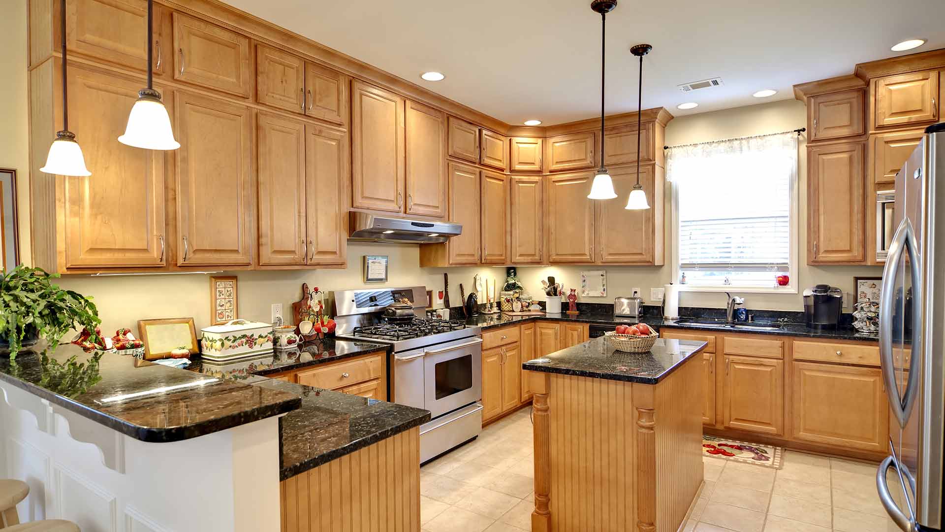 kitchen-with-light-wood-cabinets-and-black-marble-countertops-newport-news-va